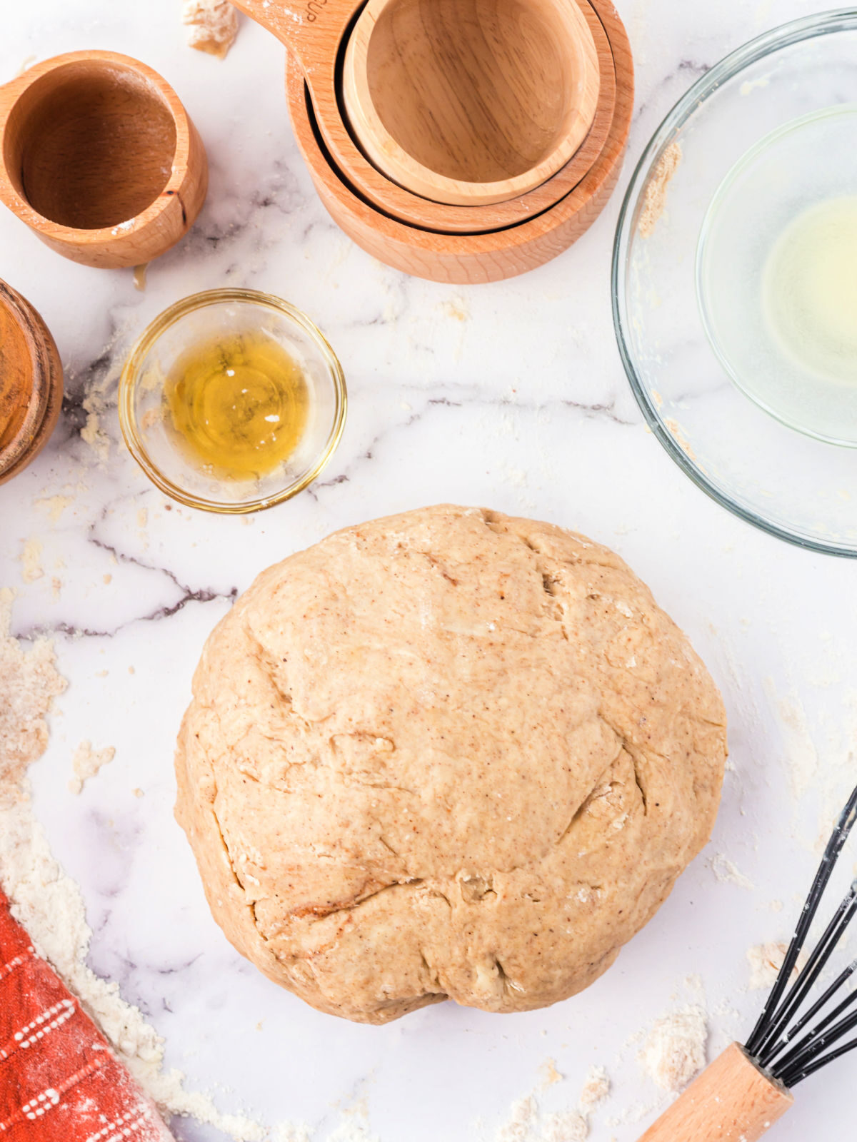 Ball of maple doughnut dough on a counter.