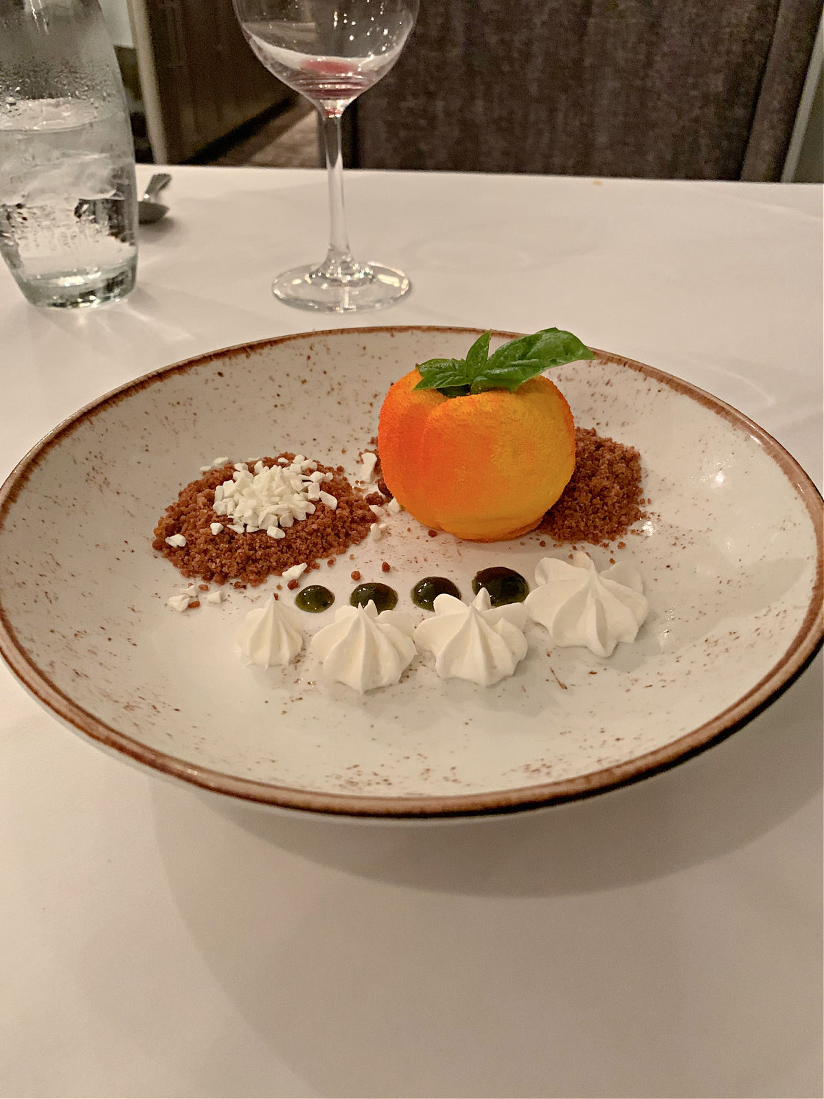 Peach cheesecake with graham cracker sand, yogurk cremeux, and basil gel.