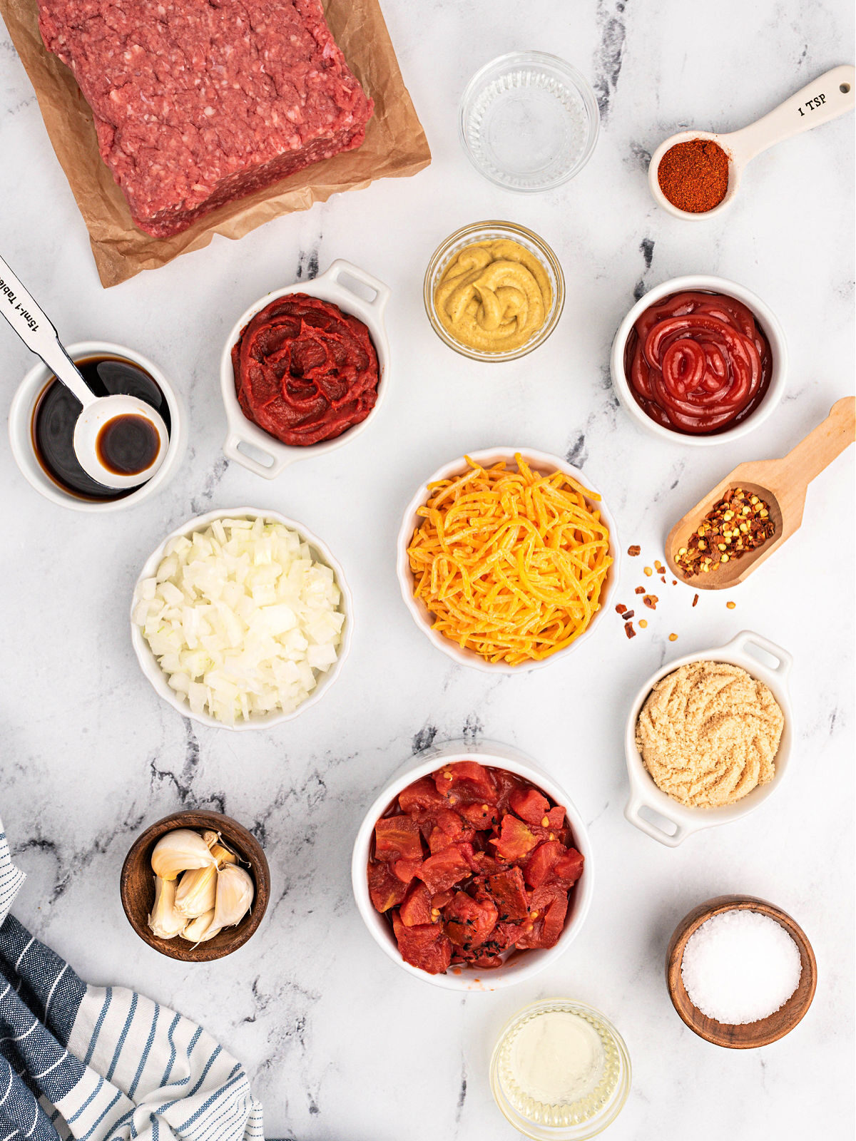 Ground beef, diced tomatoes, catsup, mustard, salt, and Cheddar cheese.