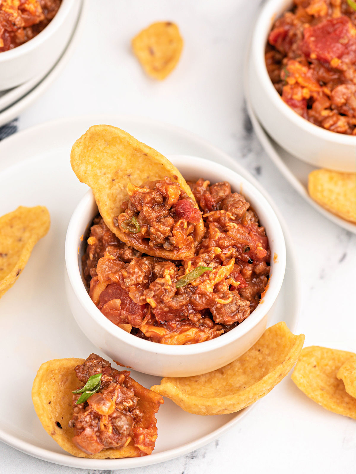 Corn chip with scoop of sloppy Joe dip.