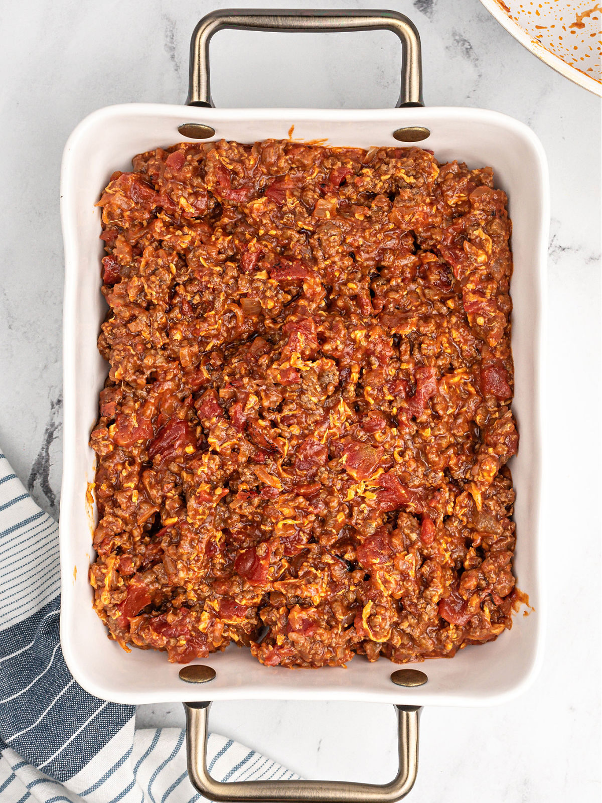 Sloppy Joe beef in a white casserole dish.