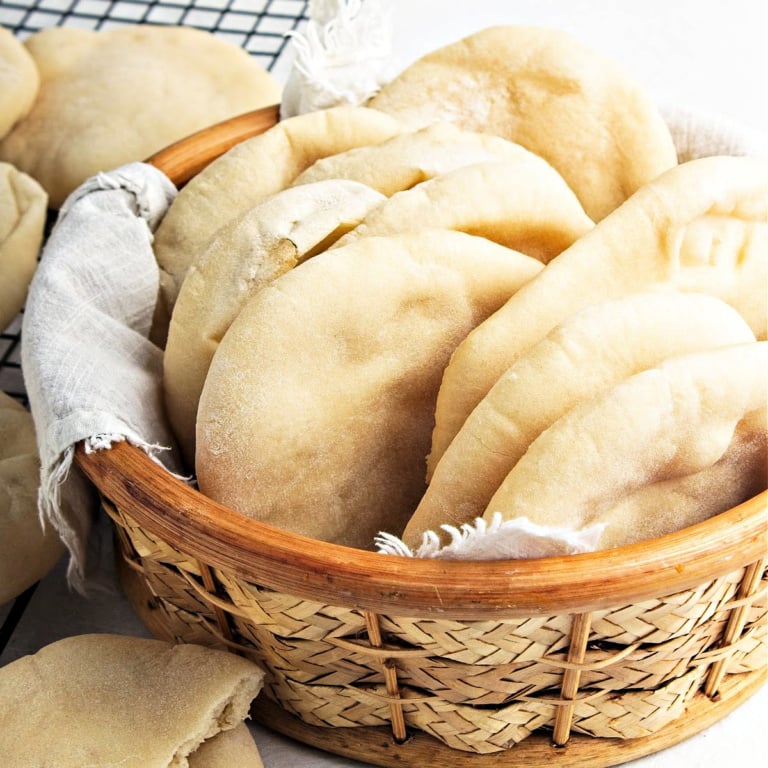 Basket with small pita bread loaves.