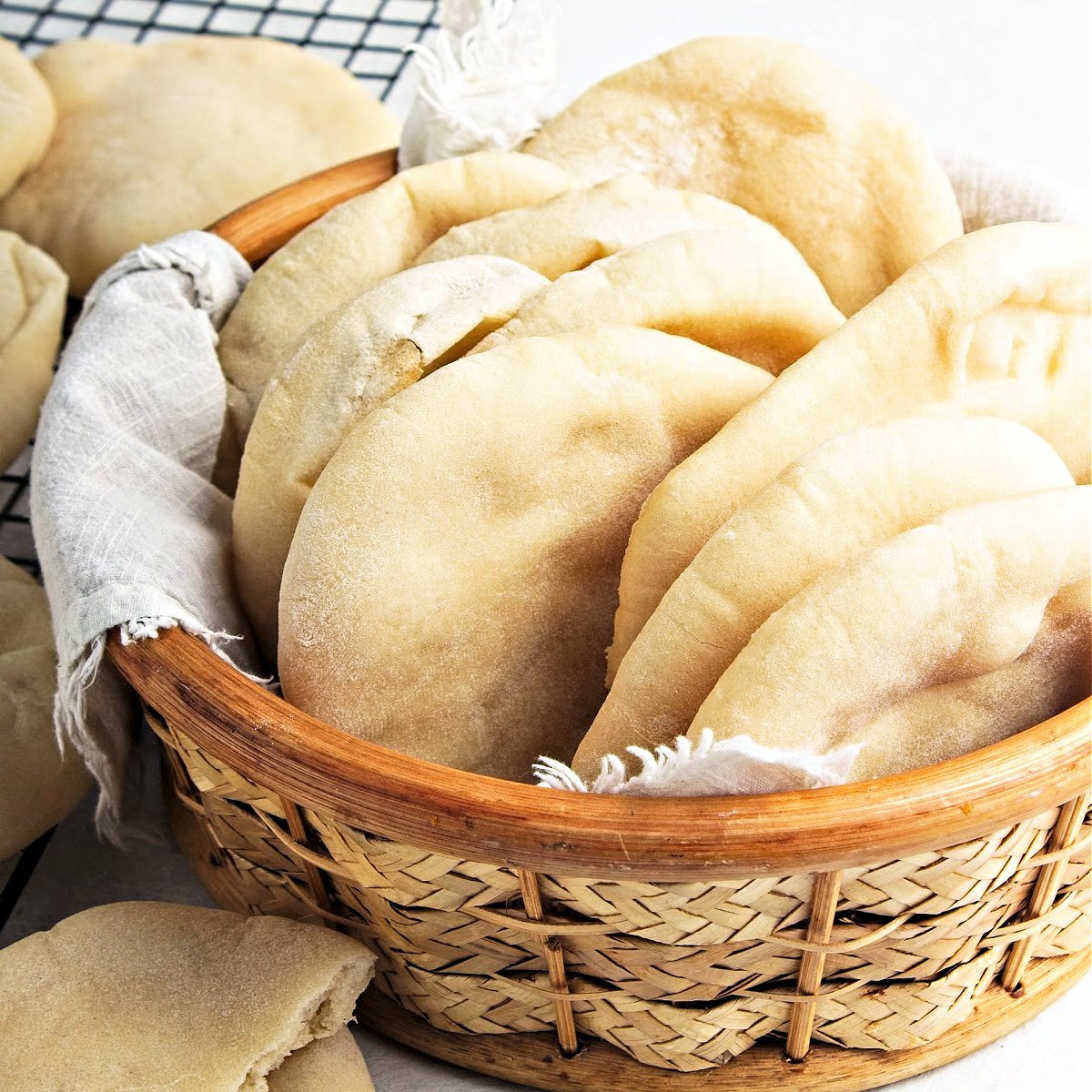 Basket with small pita bread loaves.