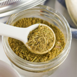 Small glass jar filled with homemade poultry seasoning.