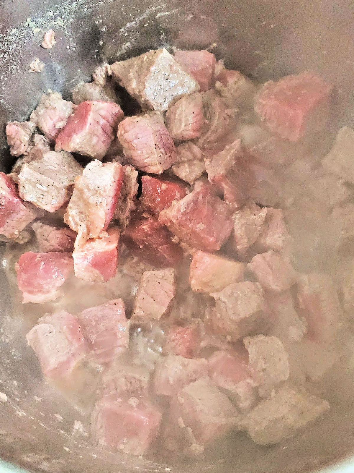 Beef cubes cooking in an Instant Pot.