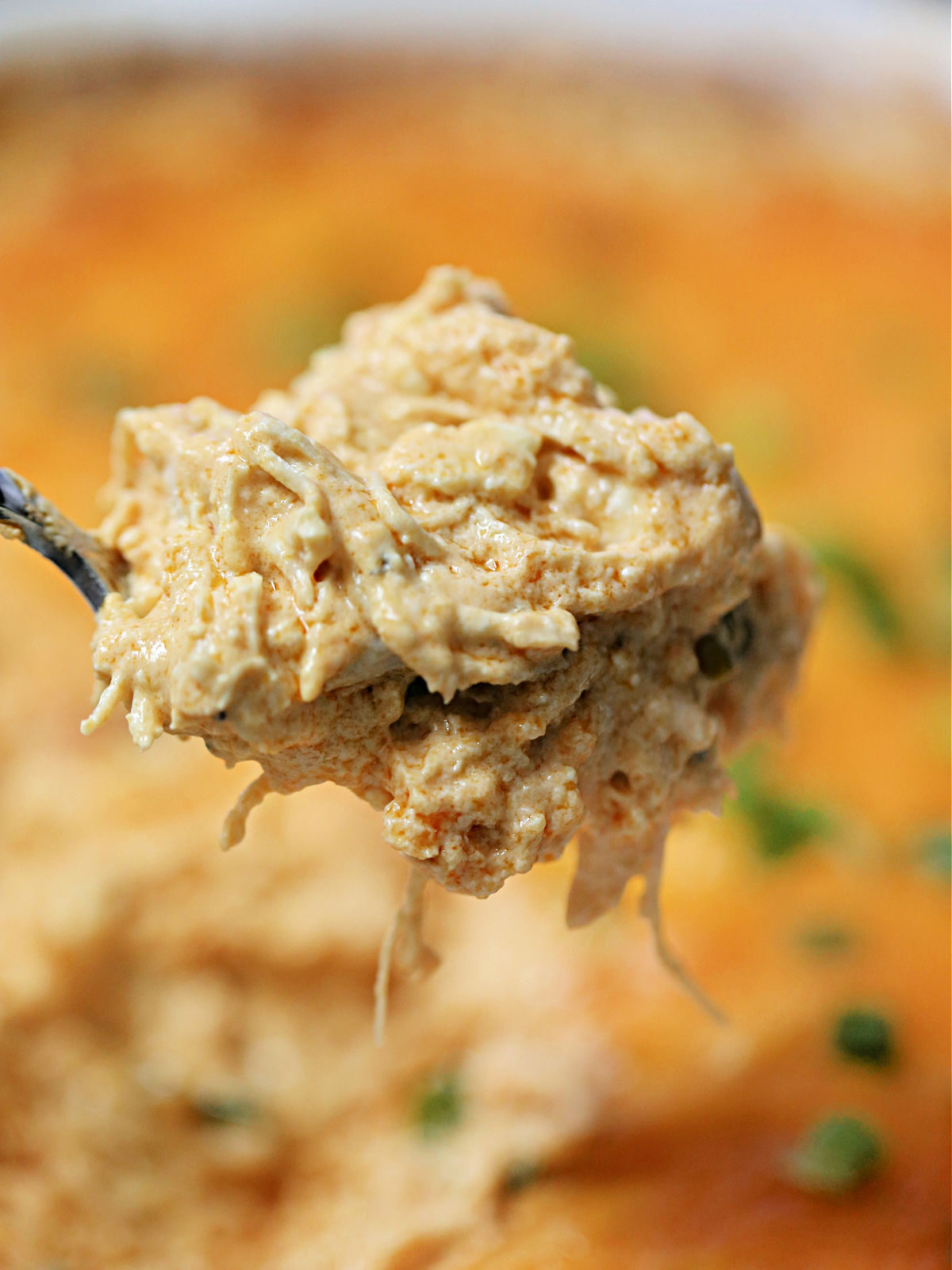 Scoop of buffalo dip on a spoon.