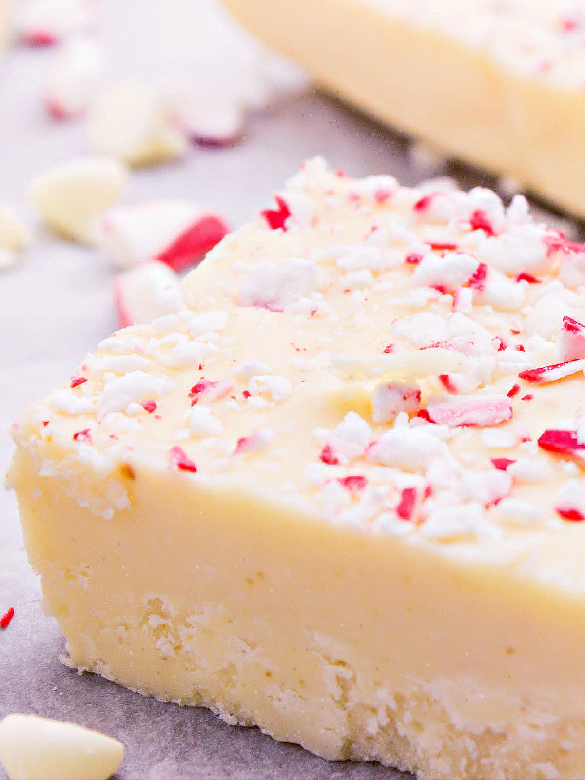 Slice of white chocolate fudge topped with peppermint pieces.