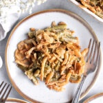 Green bean casserole on a plate with a fork.