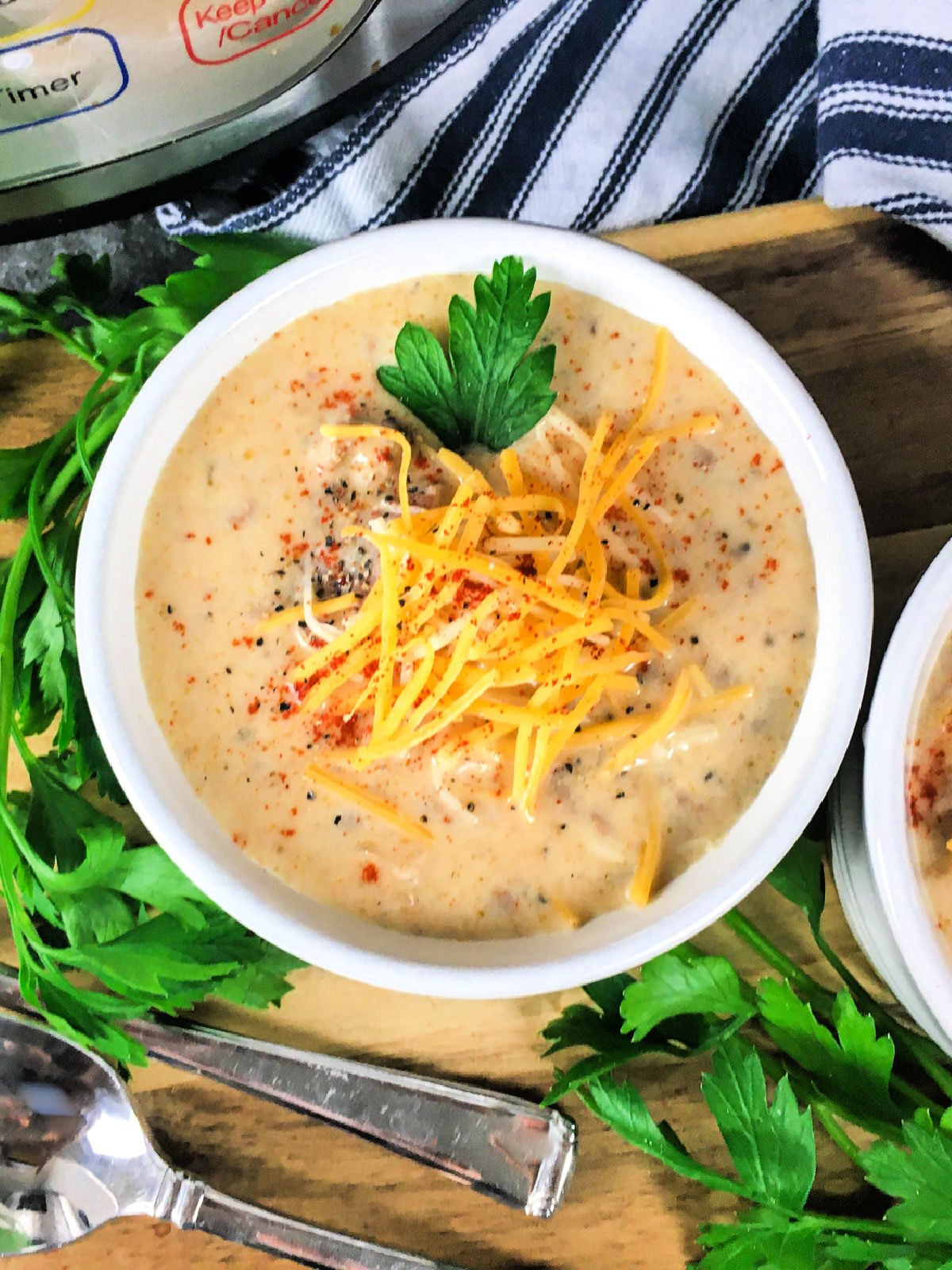 Bowl of potato soup topped with Cheddar cheese.
