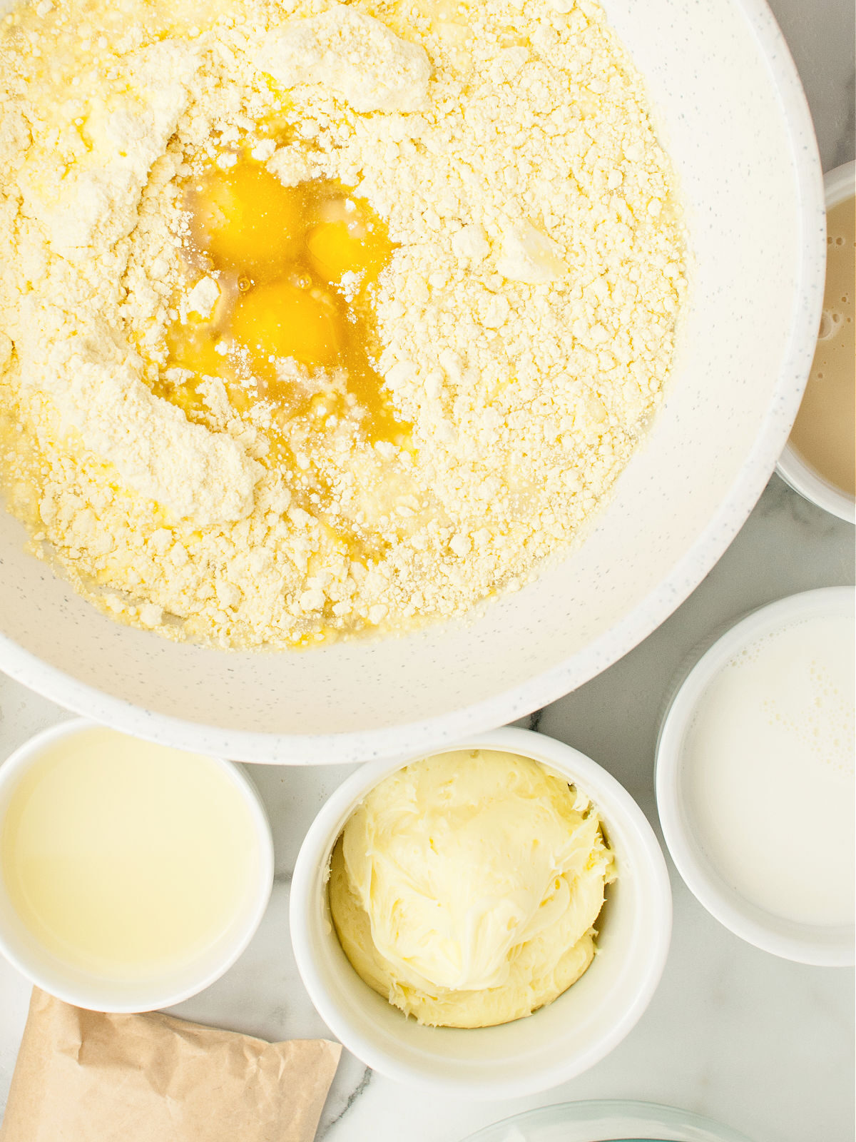 Yellow cake mix and eggs in a large mixing bowl.