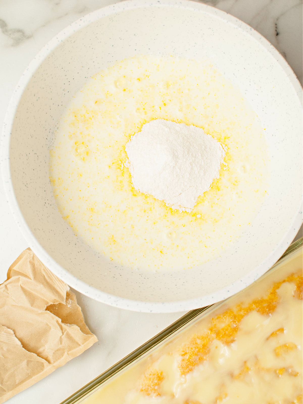 Making lemon pudding in a large bowl.