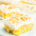 Lemon Poke Cake slice on a plate.