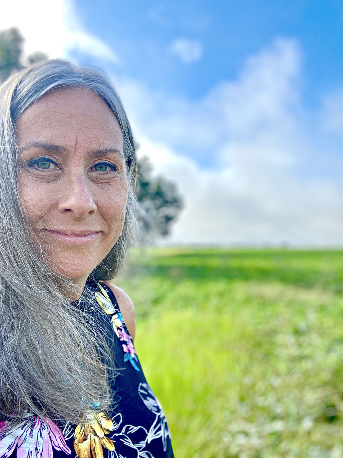 Lynda standing in front of a field of peanuts.