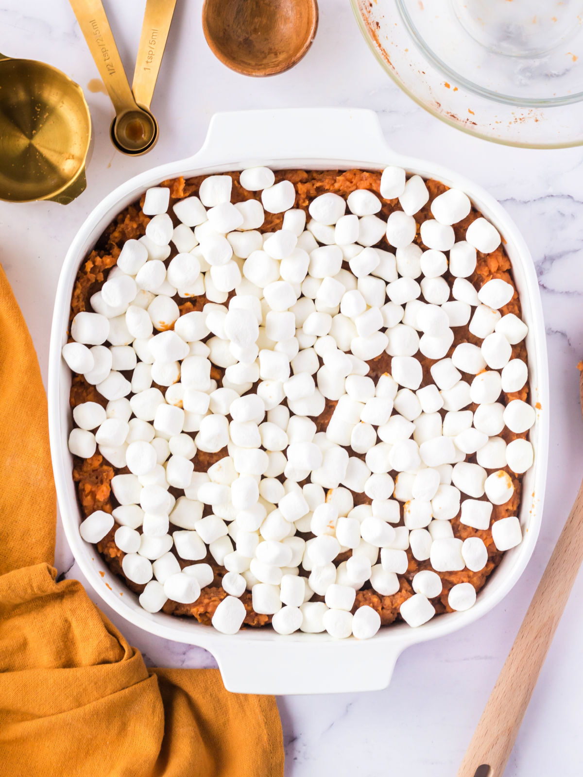 Sweet potato casserole covered with miniature marshmallows.