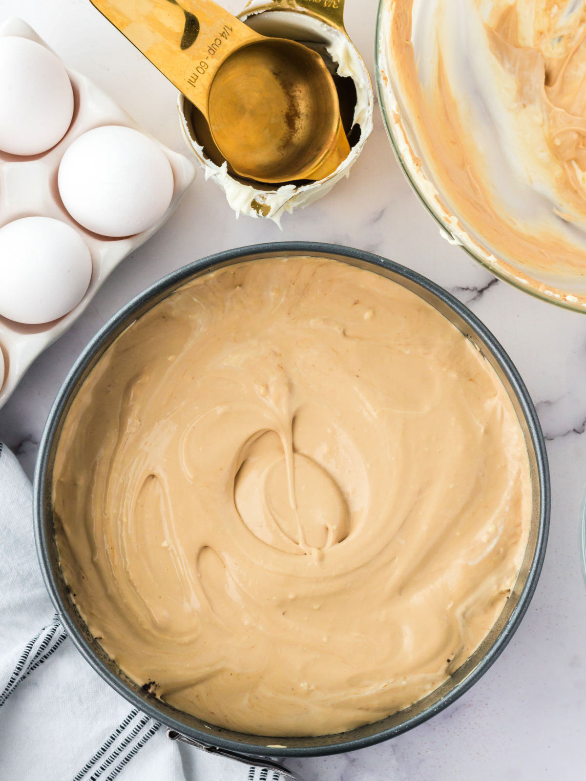 Unbaked cheesecake in a springform pan.