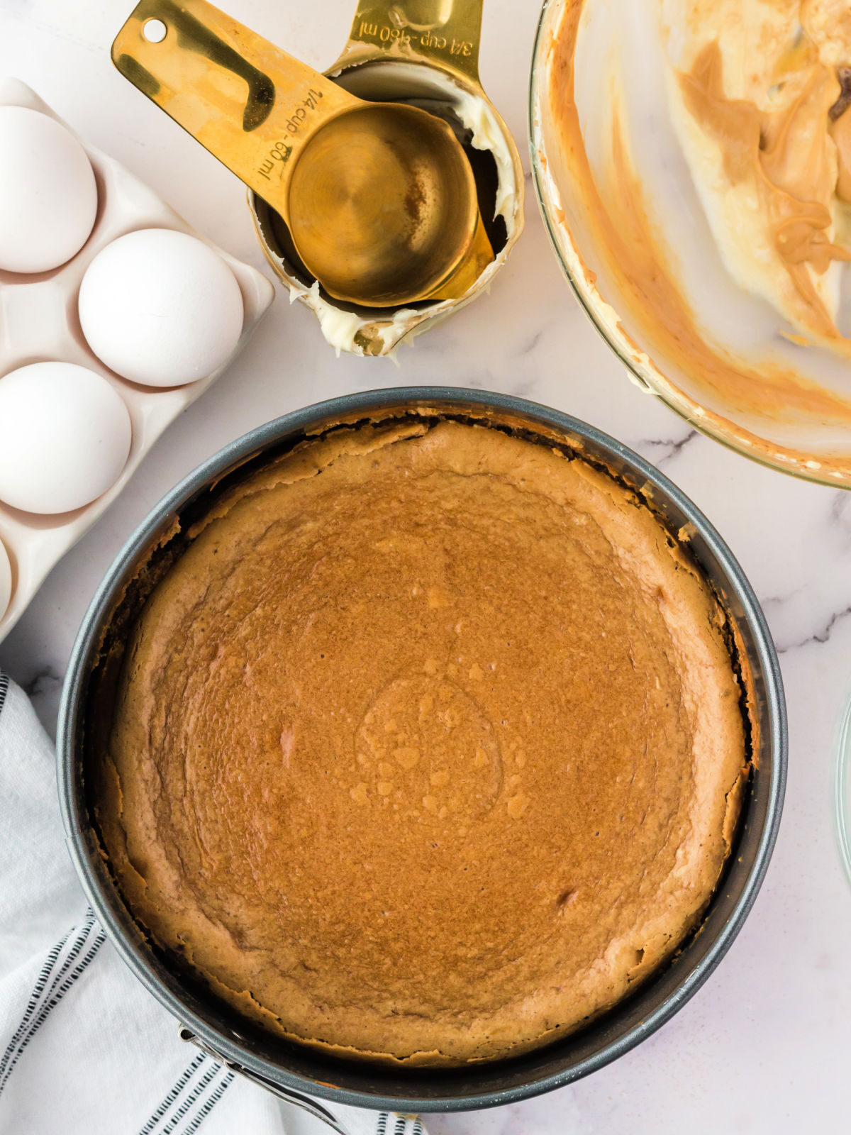 Baked tiramisu cheesecake in a springform pan.