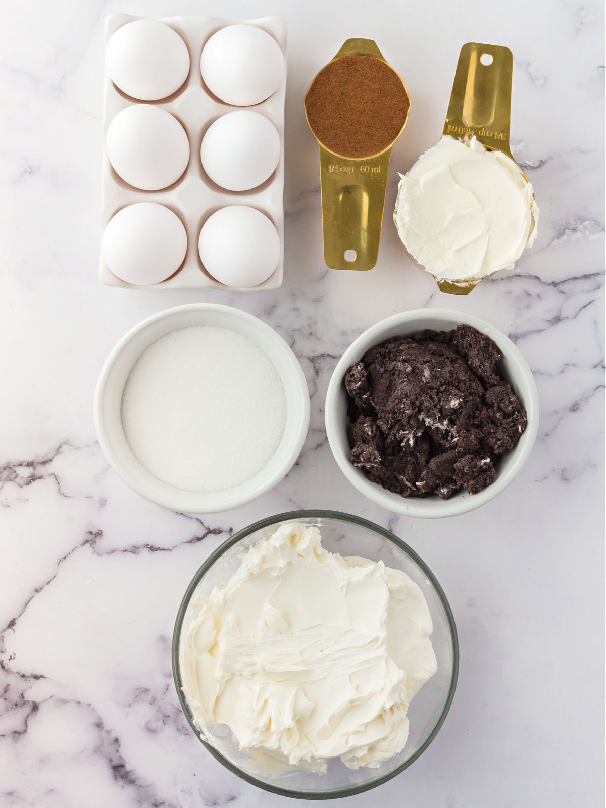 Cream cheese, crushed Oreos, eggs, sugar, and instant coffee.