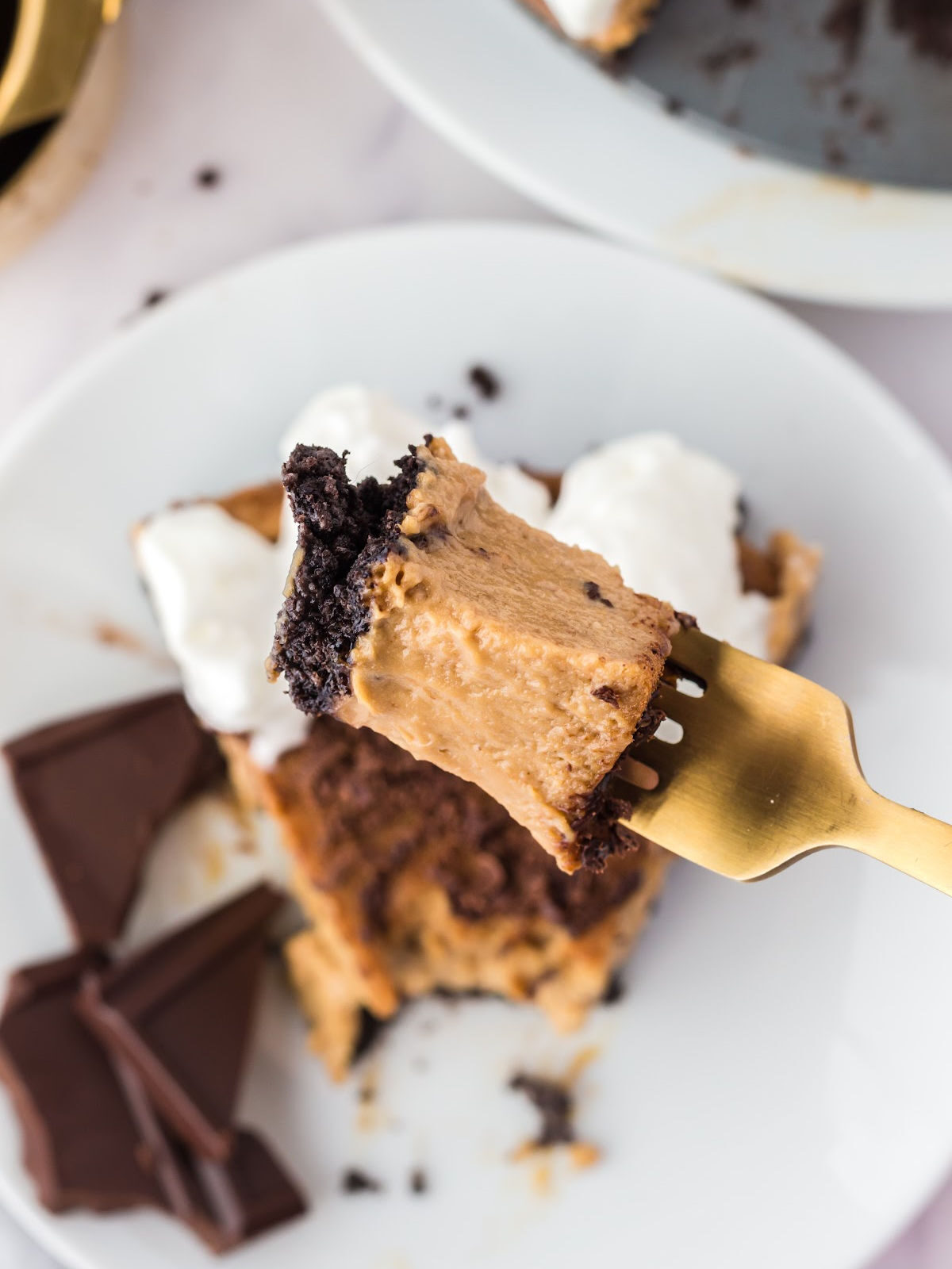 Bite of tiramisu cheesecake on a fork.