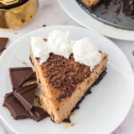 Slice of tiramisu cheesecake on a white plate.