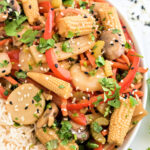 Stir fried veggies in a bowl with rice.