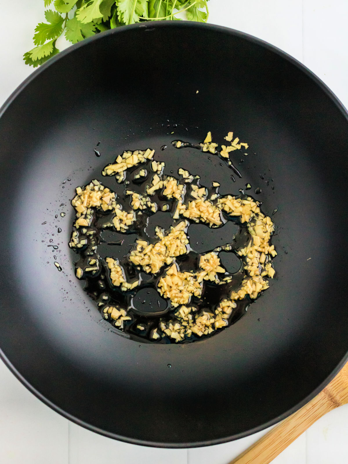 Sautéing ginger in a wok.