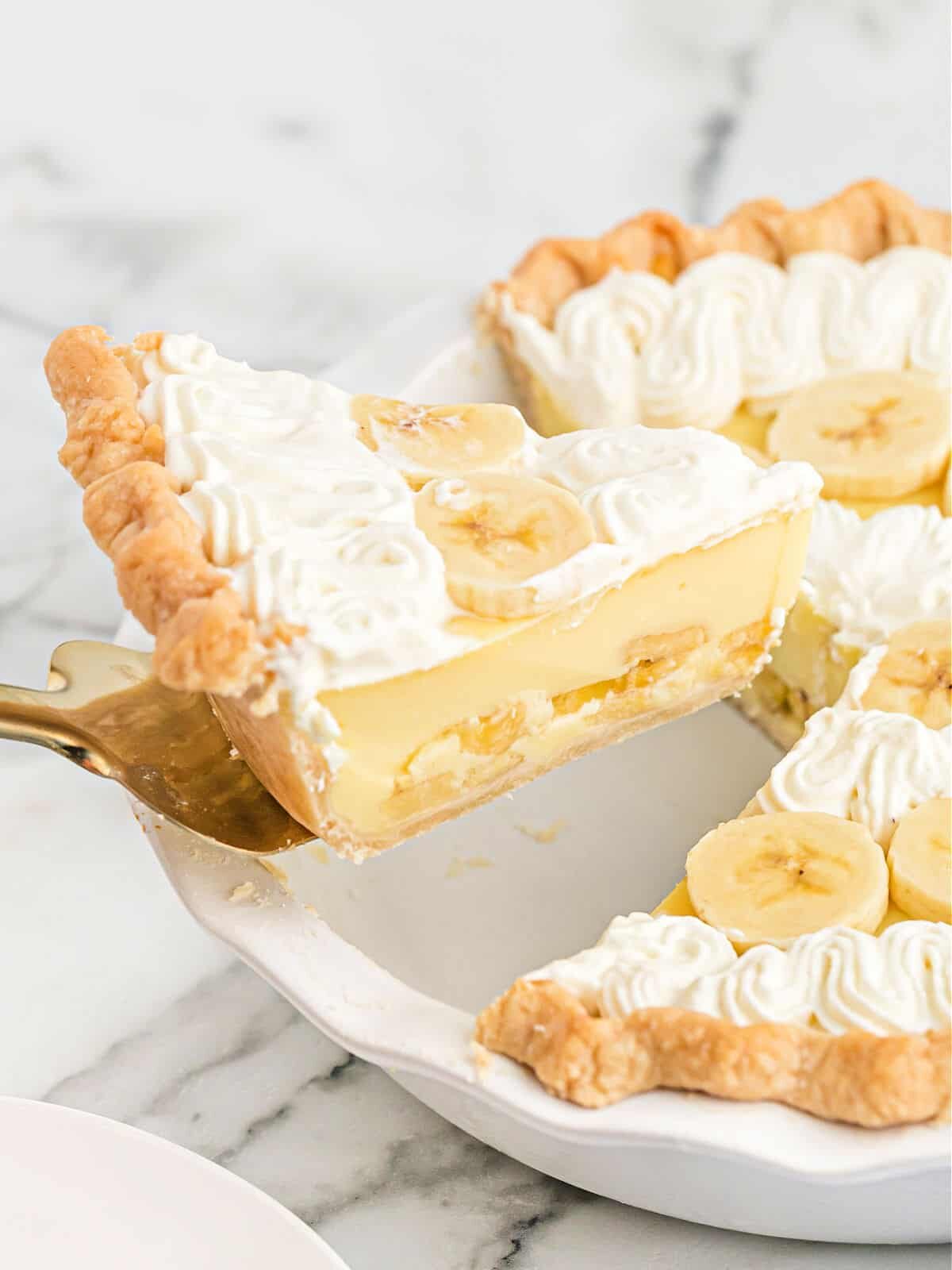 Removing a slice of banana pie.
