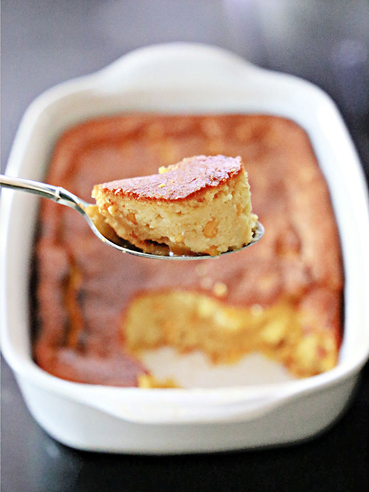 Scoop pf corn pudding on a spoon.