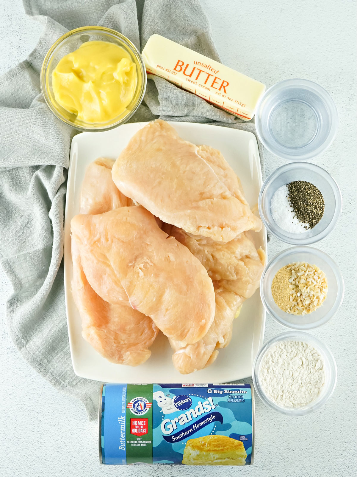 Chicken breasts, canned biscuits, seasoning, butter, and cream soup.