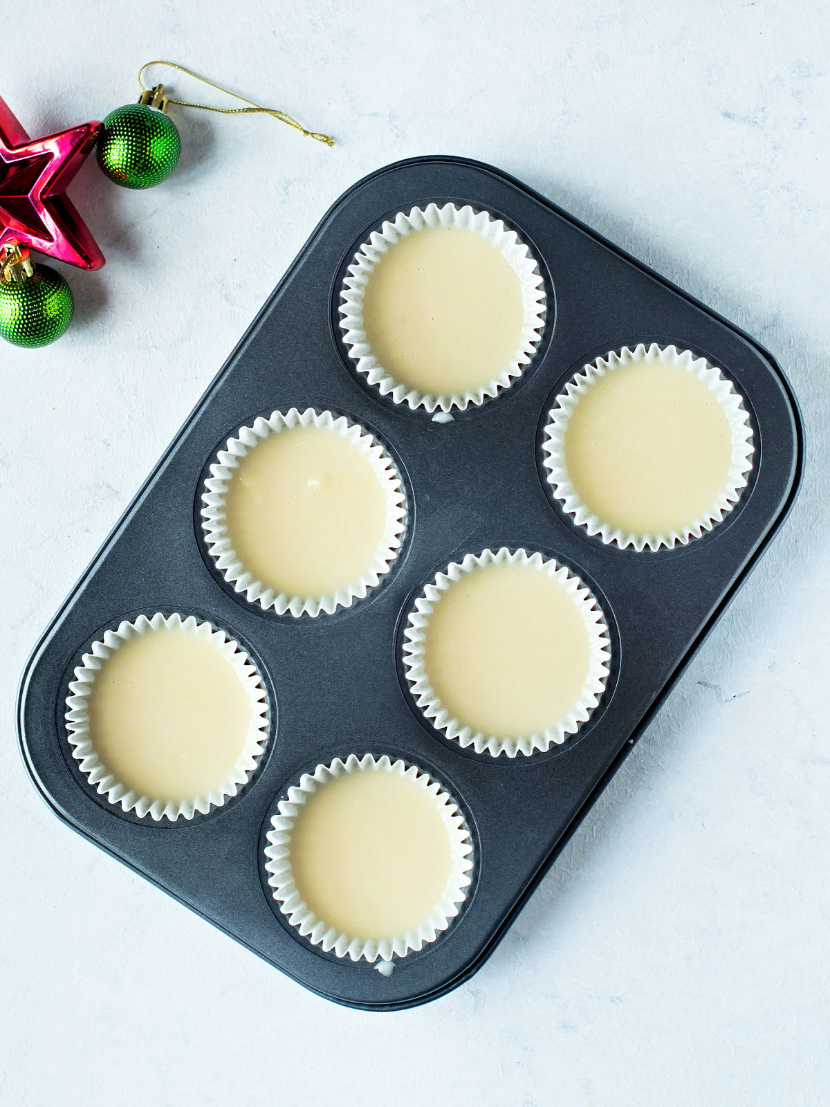 Vanilla cupcakes in muffin tins.