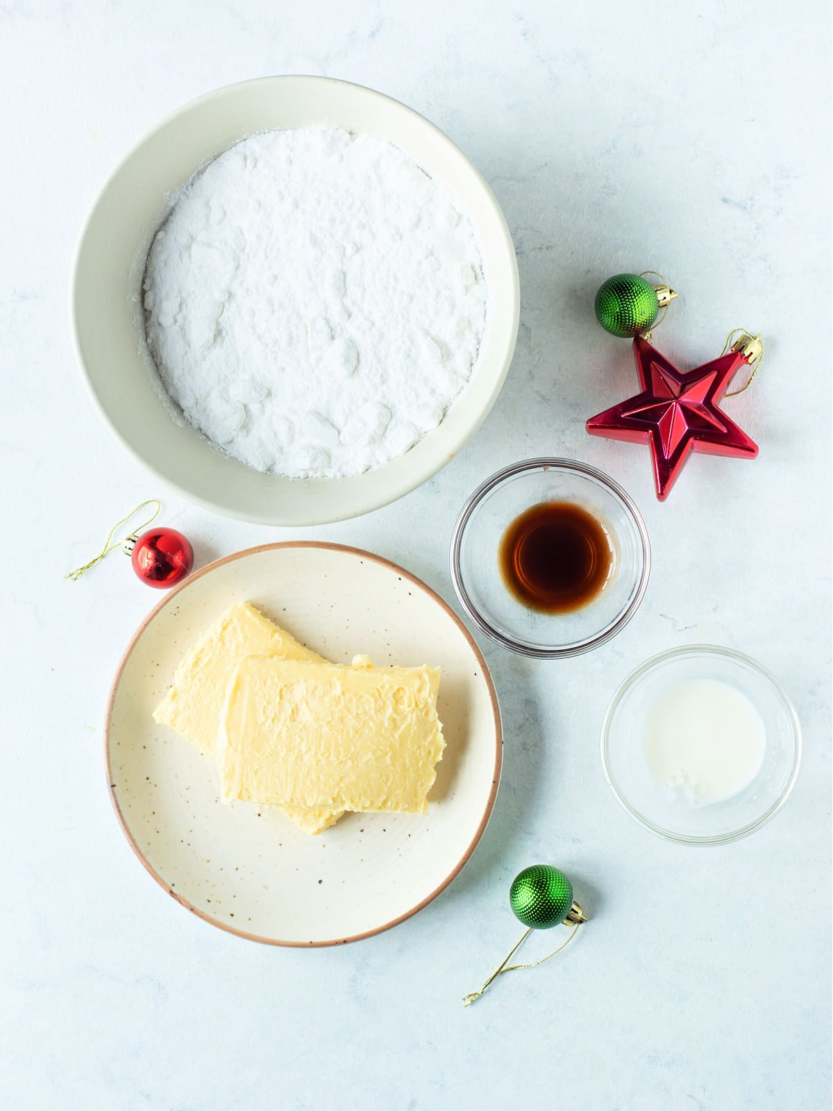 Flour, butter, and vanilla in glass bowls.