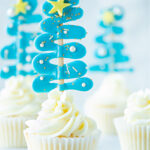 Christmas cupcakes with blue Christmas trees.