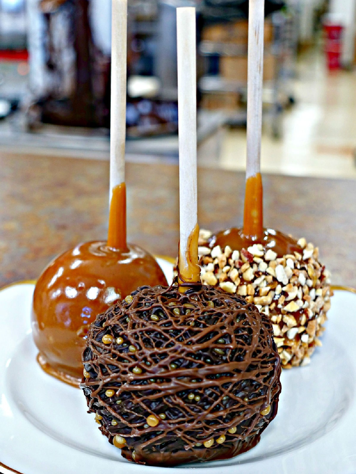 Plate with three caramel apples.