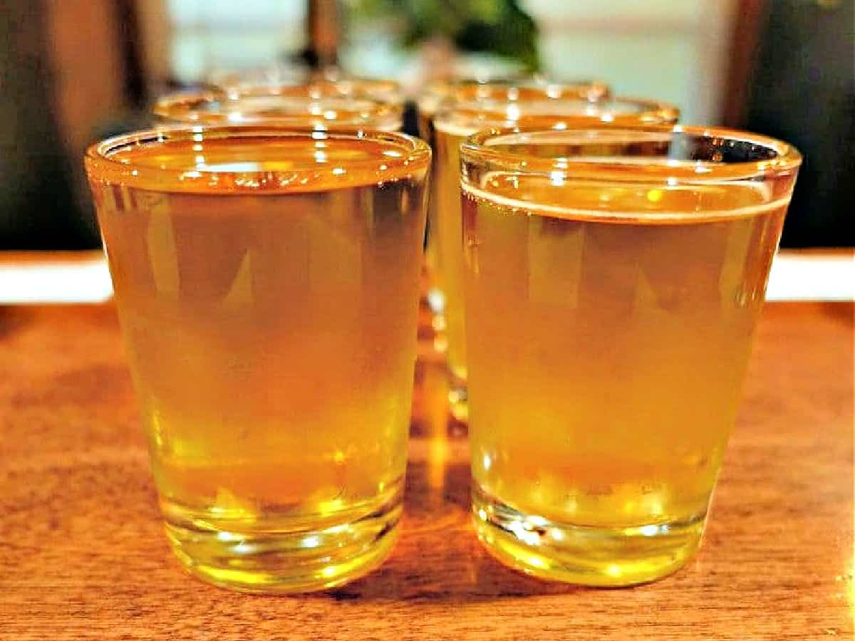Real Rootbeer Shot glasses filled with root beer on a bar.