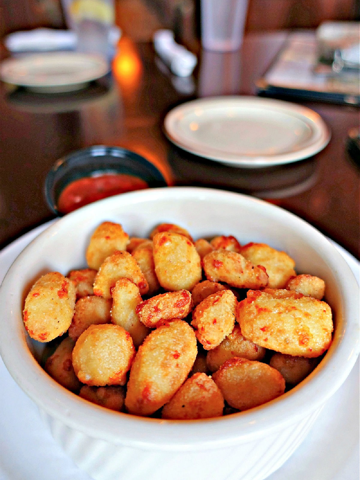 Wisconsin Fried Cheese Curds Fried cheese curds in a white bowl.