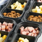 Meal prep protein packs filled with meat, cheese, and nuts.