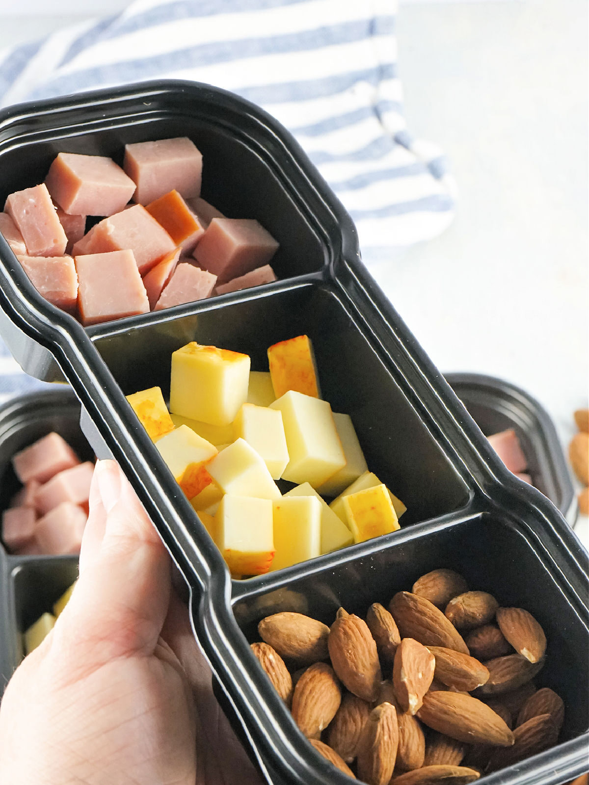 Woman's hand holding a protein pack.