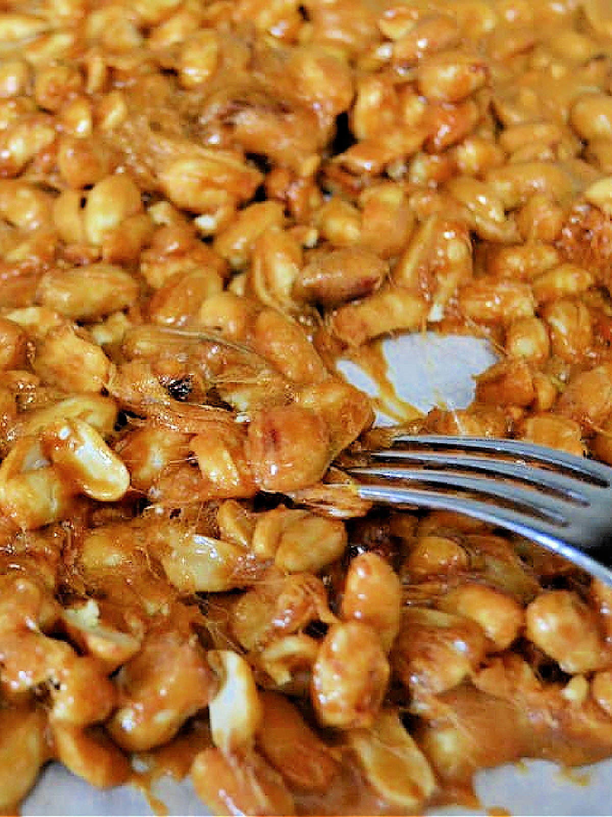 Pulling peanut brittle with a fork.