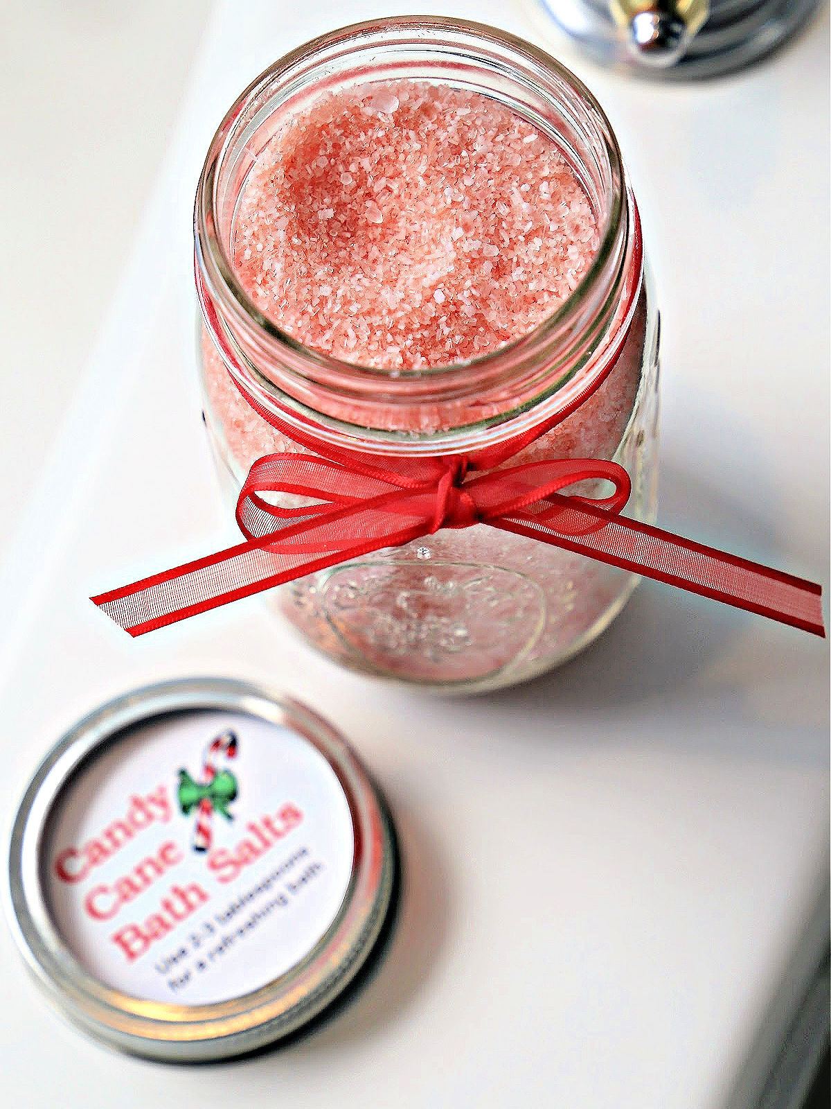 Jar of peppermint bath salts tied with a red ribbon.