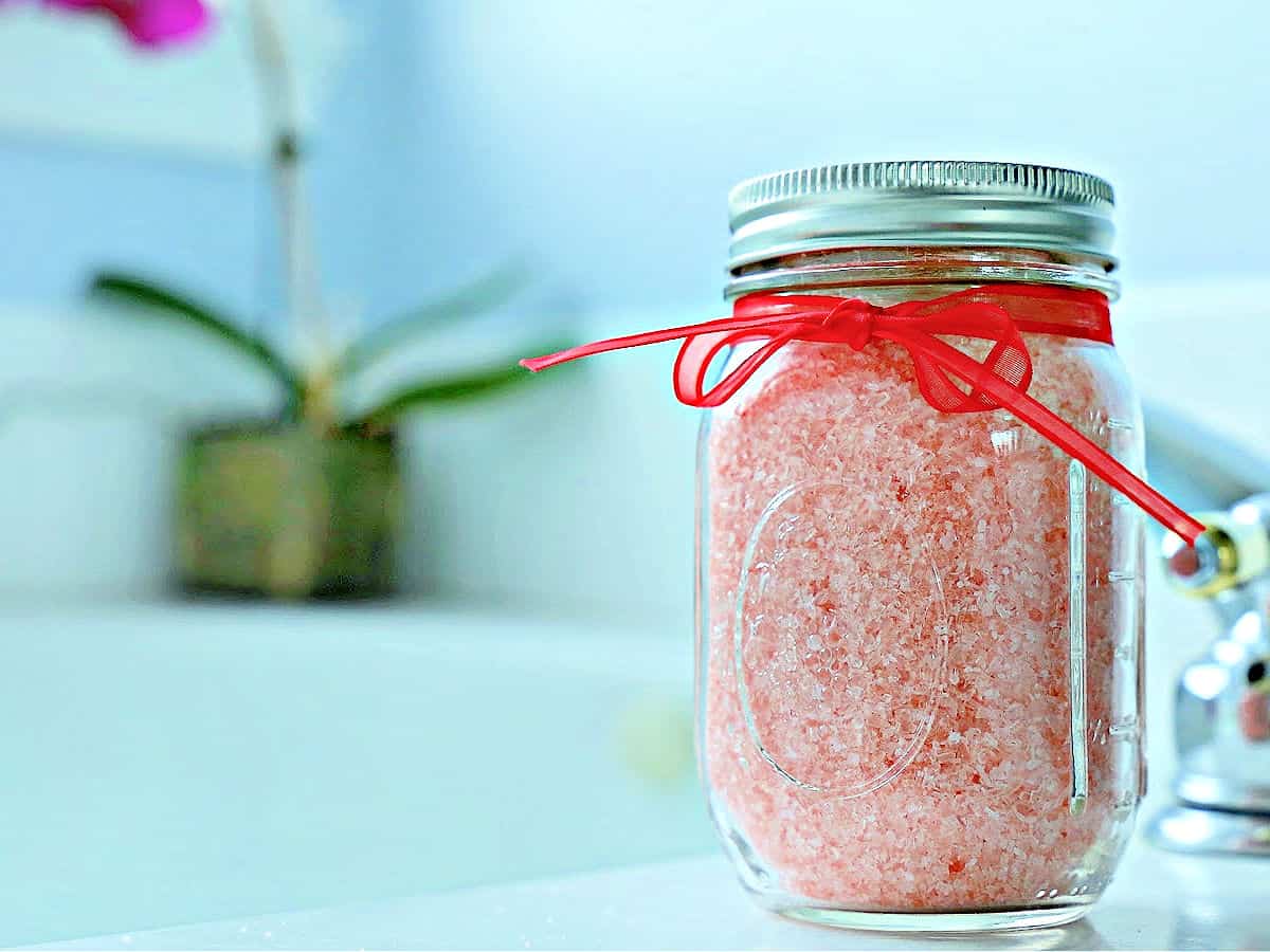 Peppermint bath salt in a jar tied with a red bow.