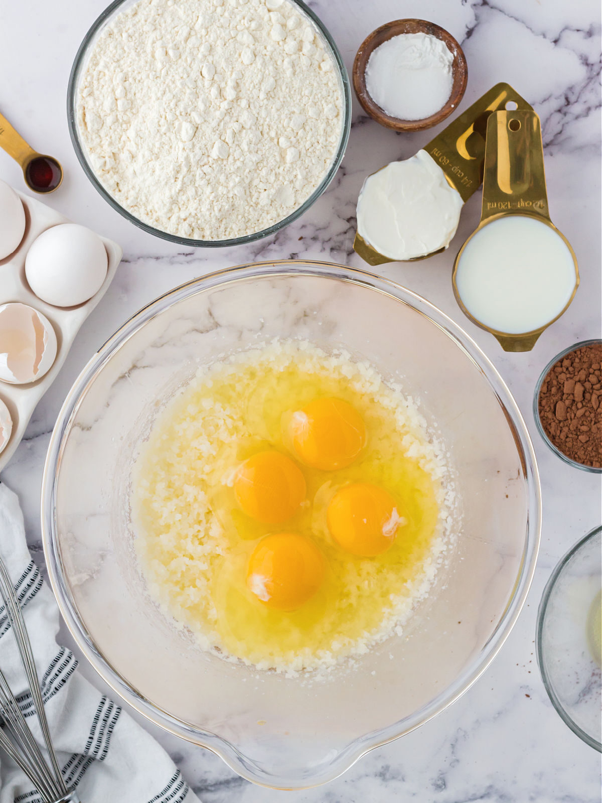Eggs and butter in a glass mixing bowl.