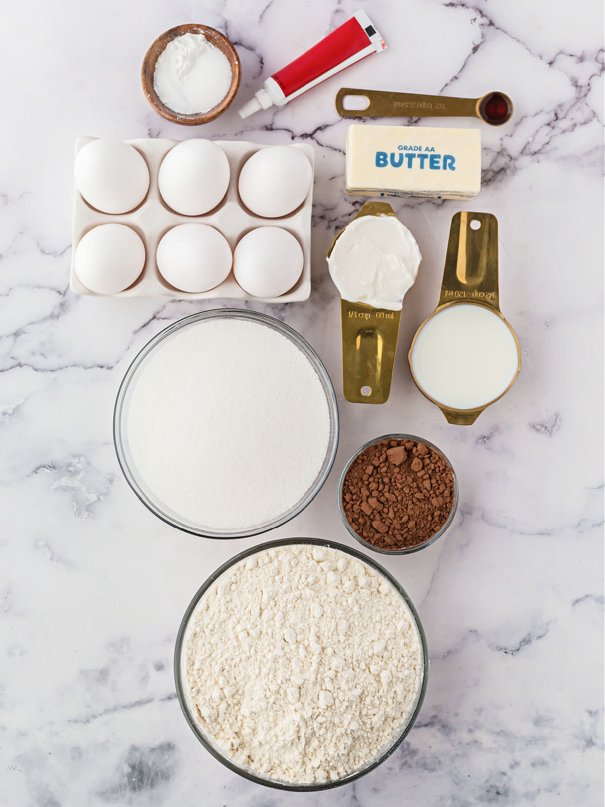 Flour, sugar, cocoa powder, sugar, eggs, shortening, butter, and red food coloring.