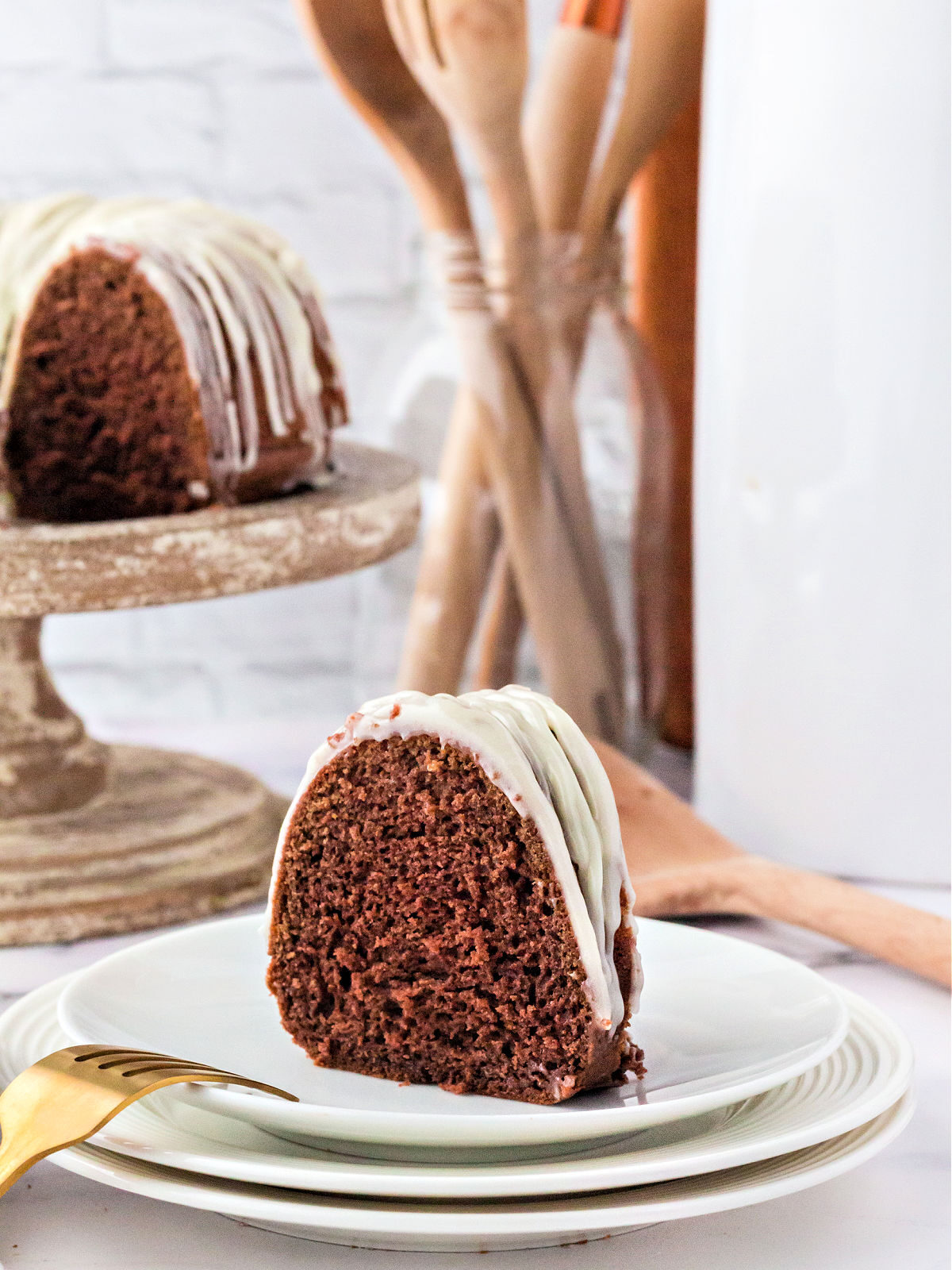 White plate topped with a slice of Red Velvet Bundt Cake.
