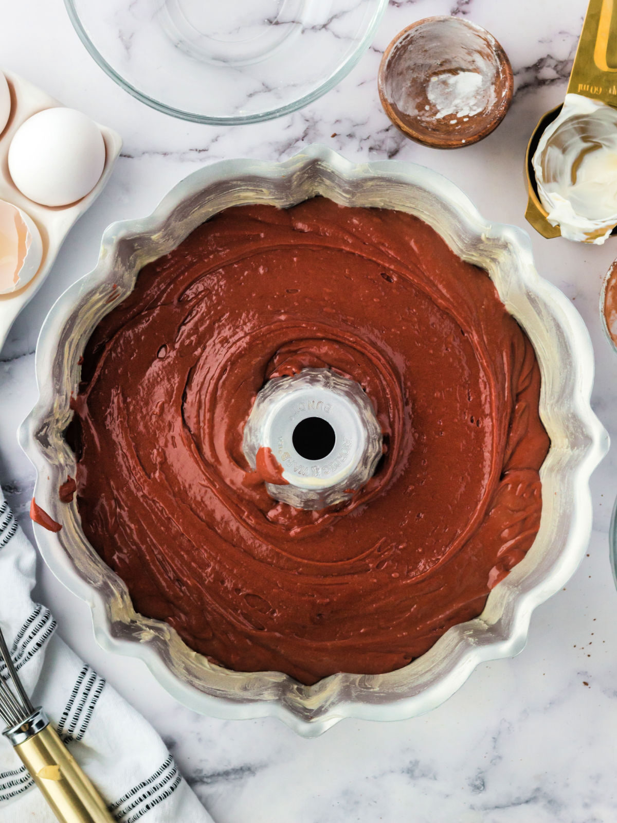 Red velvet cake batter in a Bundt pan.