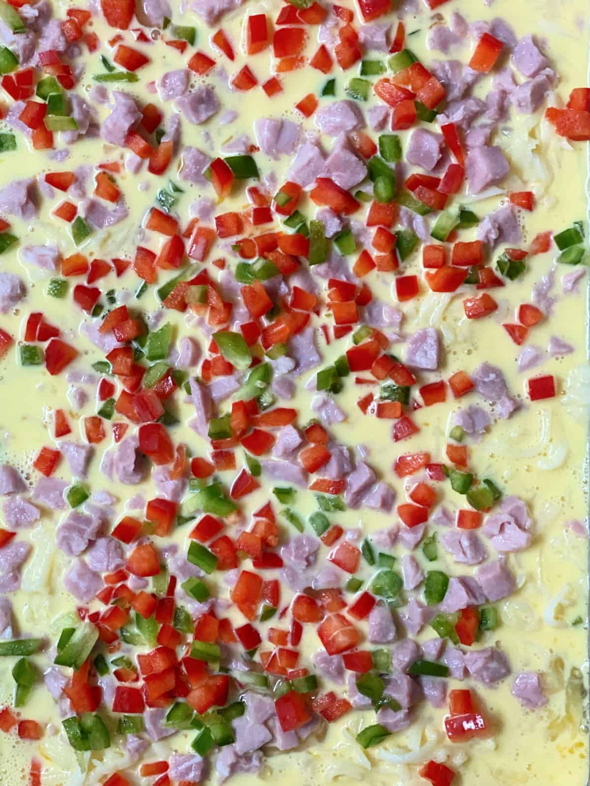 Bell peppers on top of ham in breakfast casserole.