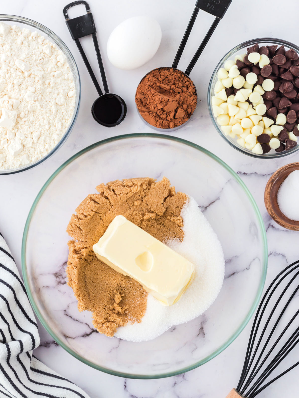 Sugar, brown sugar, and butter in a glass mixing bowl.