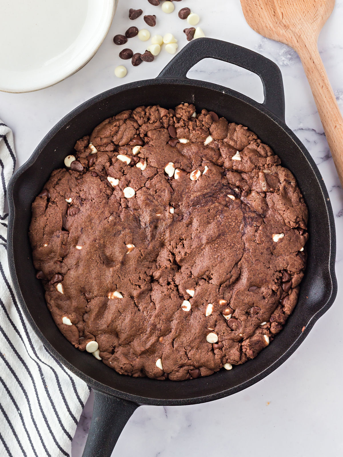 Baked triple chocolate pizookie in a cast iron skillet.