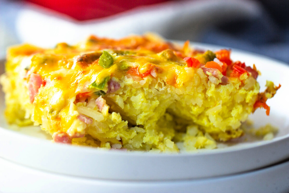 Egg casserole with peppers and onion on a plate.