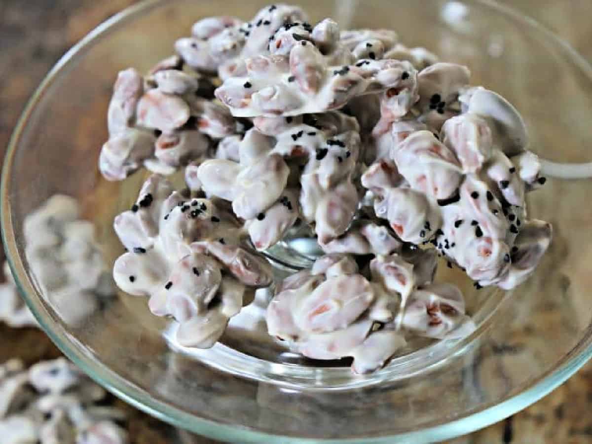 Almonds coated in vanilla almond bark and topped with black sea salt.