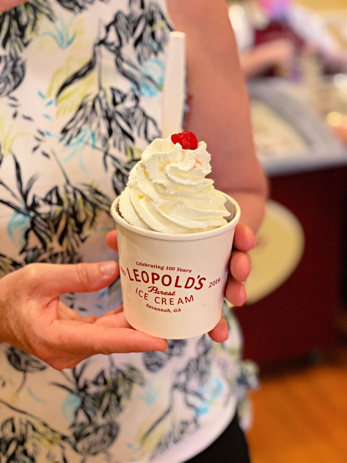 Woman holding a brownie sundae.