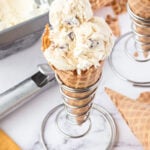 Waffle cone filled with cookie dough ice cream.